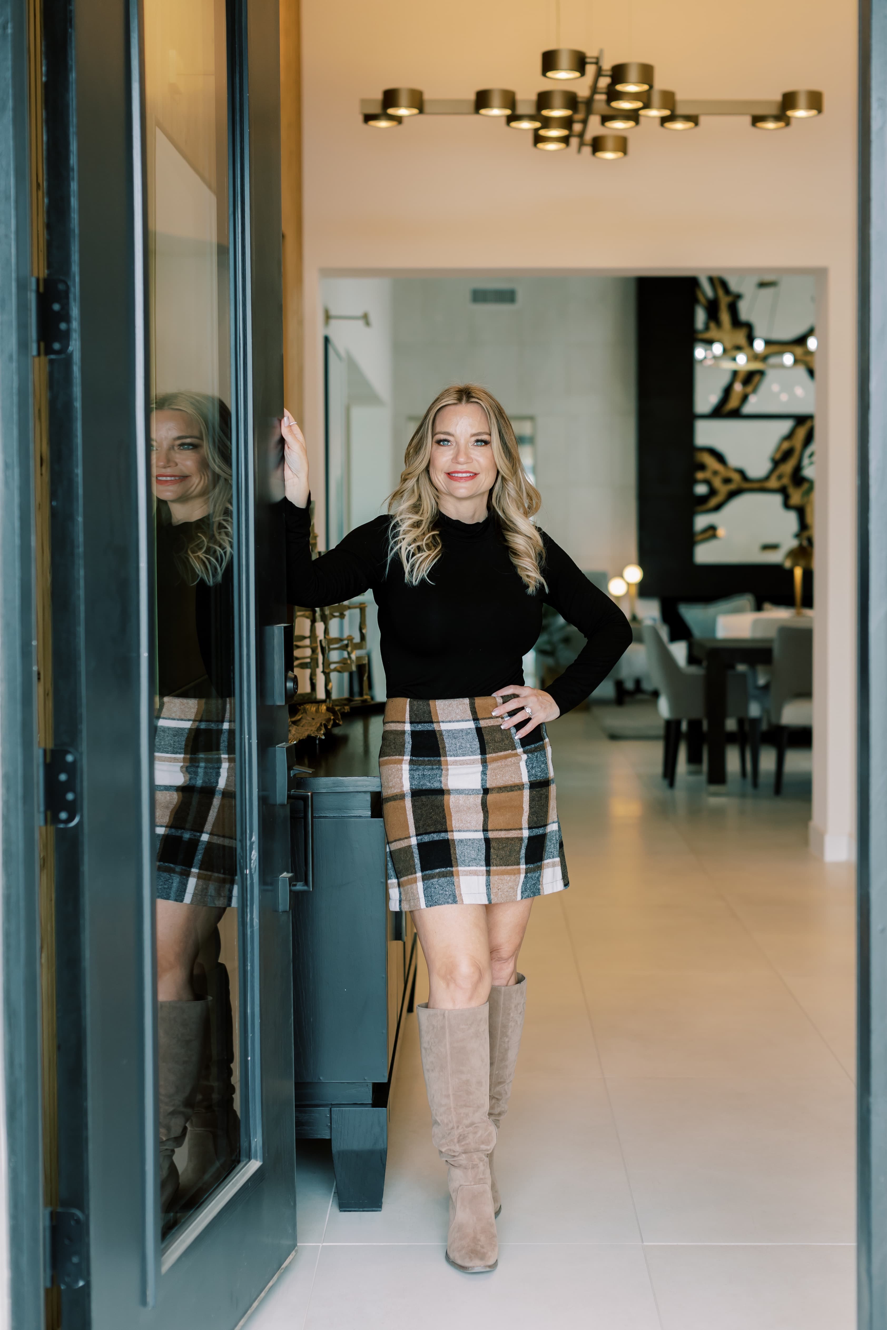 Wendy Macica, Southeast Valley Realtor, standing in the entryway of a modern Southeast Valley home